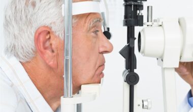 Close-up side view of a senior man getting his cornea checked